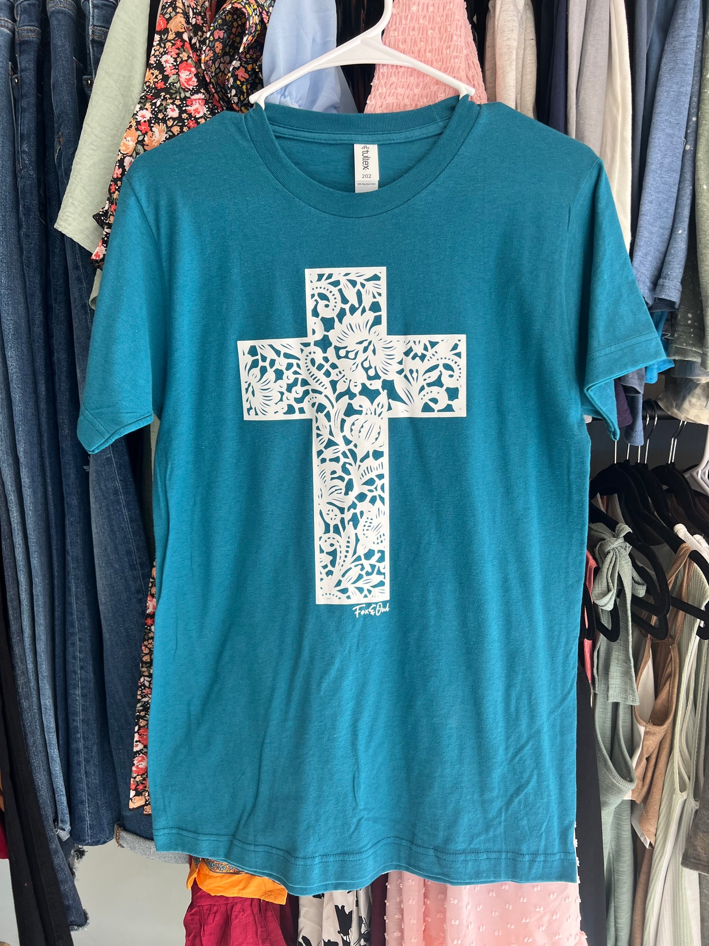 Teal and white cross graphic